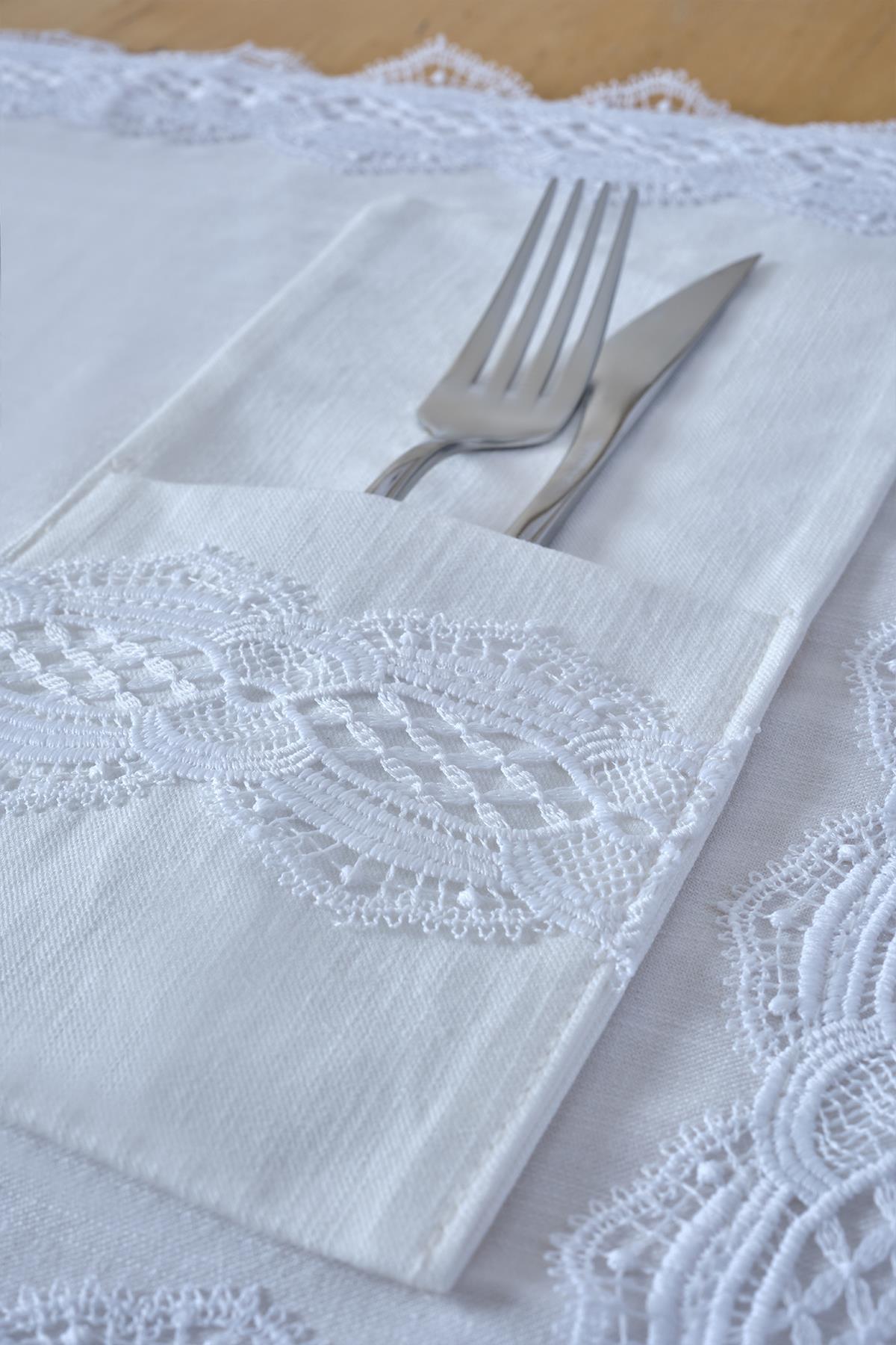 Tenedor y cuchillo en servilletero de tela blanca con detalles de encaje, decoración de mesa