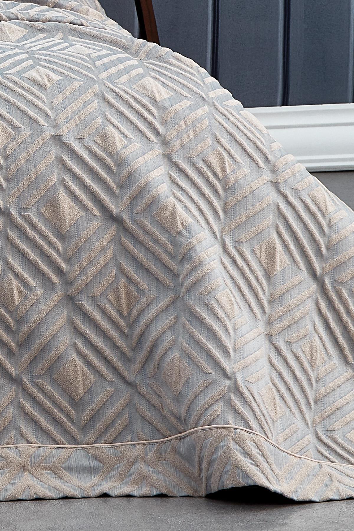 Vista detallada de colcha matrimonial de jacquard con patrón geométrico en gris y beige