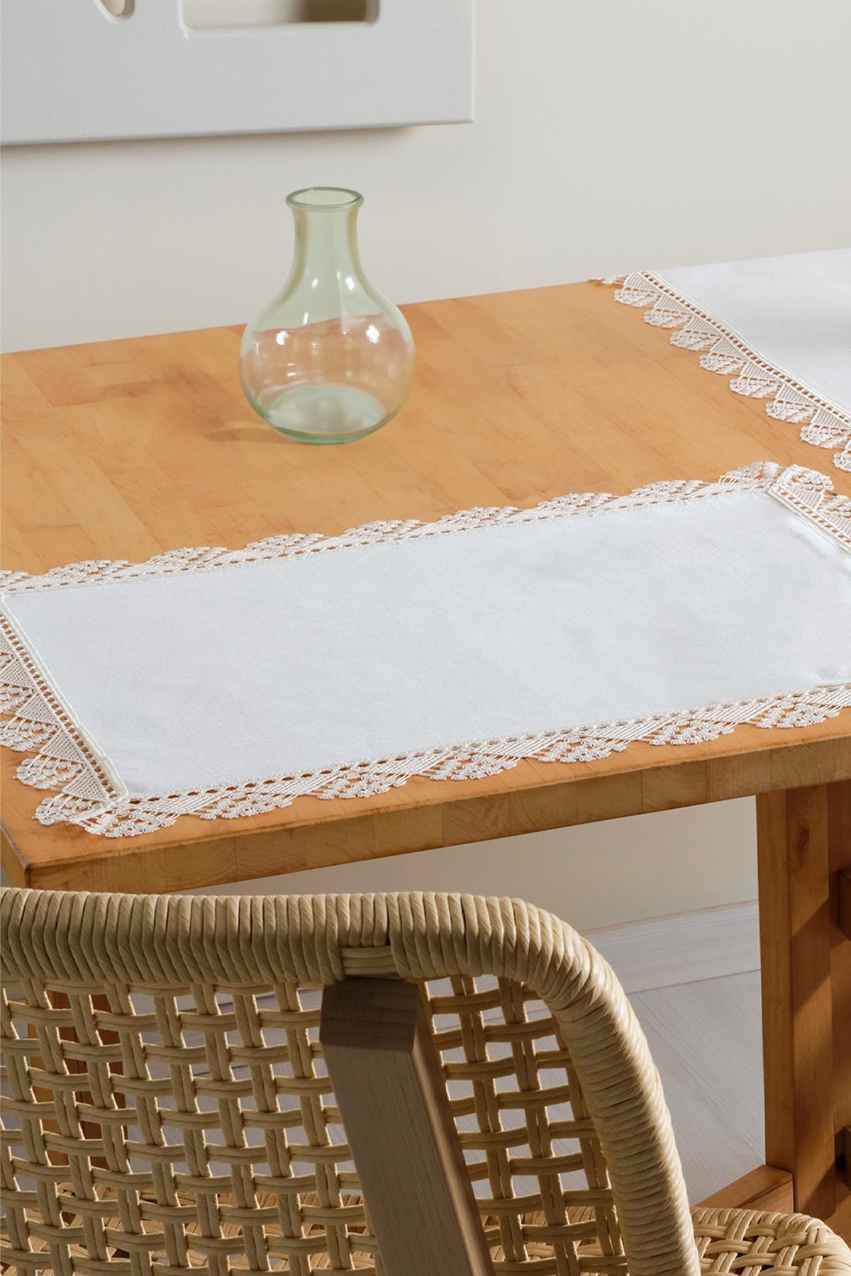 Mantel individual blanco con borde de encaje sobre mesa de madera, decoración de mesa con jarrón de cristal